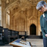 Close up person looking at old interpretation panel Divinity School