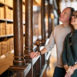 Smiling couple in front of Arts End lower shelving